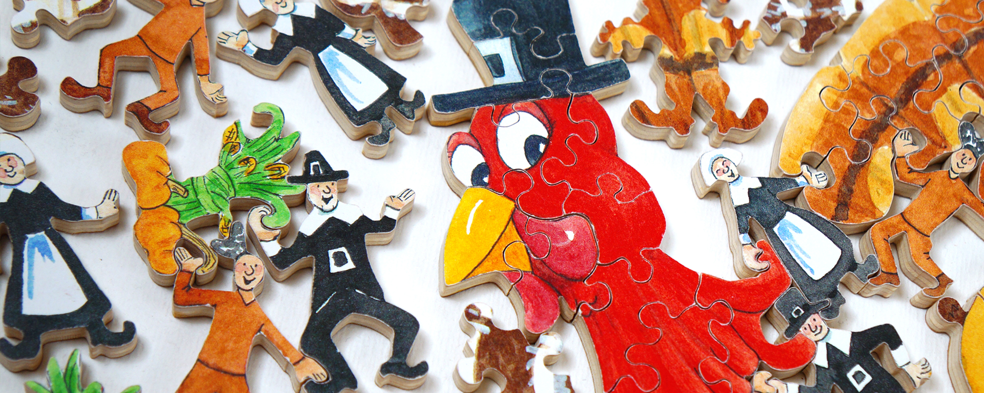 Wooden Thanksgiving jigsaw puzzle of pilgrims gathering around a large pilgrim turkey.